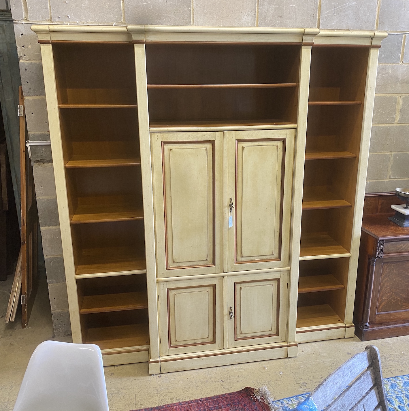 A reproduction Continental painted breakfront bookcase / media cabinet, width 204cm, depth 55cm, height 222cm